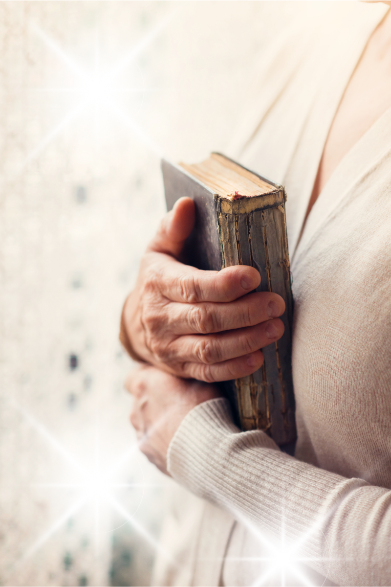 woman holding Bible to her chest